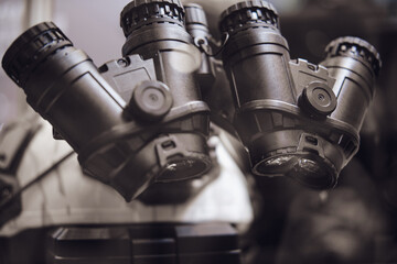 Army binoculars with night vision on a soldier's helmet. Optical device on a military helmet for tracking in war