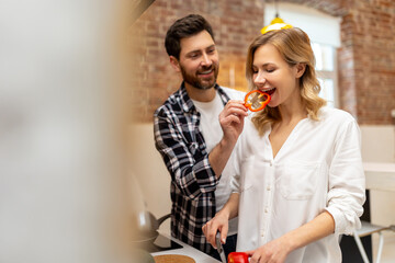 Loving young couple cutting vegetables at kitchenn counter.