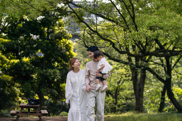 Fototapeta premium 新緑の公園を歩くファミリー
