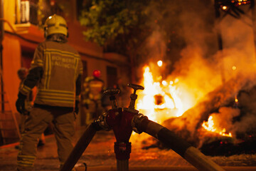 fireman and fire hydrant in the street with arson on the background