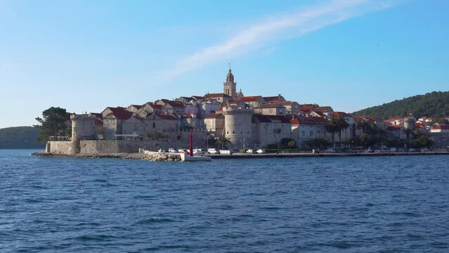 Panorama of historic town of Korcula shoot from a cruising boat. View of stone walls, towers, churchs and old houses.