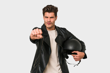 Young caucasian man holding a helmet isolated