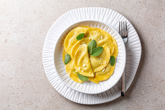 Mezzelune also known as Schlutzkrapfen in Tyrol, and German crafuncins or cajinc&igrave;,  are a semi-circular stuffed pasta, similar to ravioli or pierogi. With popato and goat cheese filling and mint.