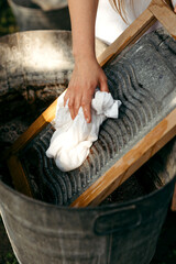 Washing clothes on a washboard in vintage style