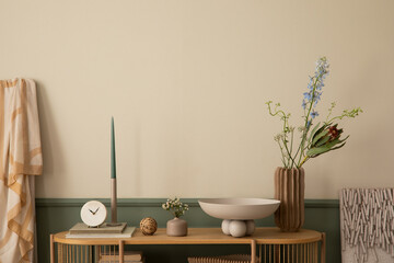 Minimalist composition of spring living room interior with wooden sideboard, stylish bowl, vase with colorful flowers, candle with candlestick and personal accessories. Home decor. Template.