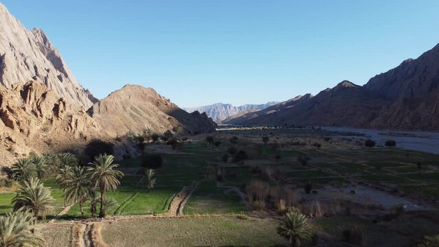 Aerial Flying Over Farmland Covered In Mountain Shadow In Khuzdar,  Balochistan. Dolly Forward