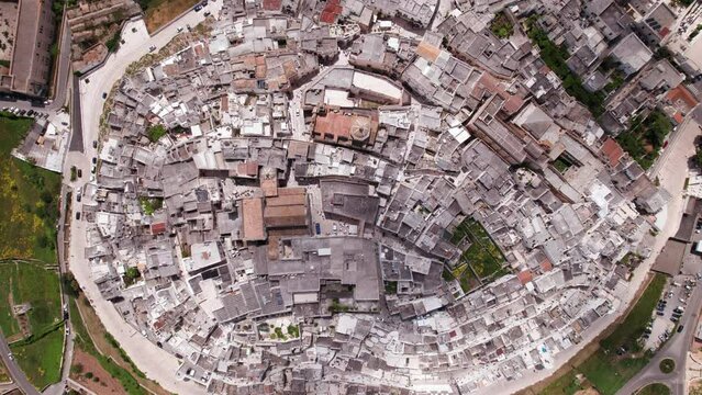Aerial bird's eye rising view of white italian town Ostuni, Puglia, Italy