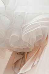 Closeup shot of a beautiful white wedding dress made of soft texture