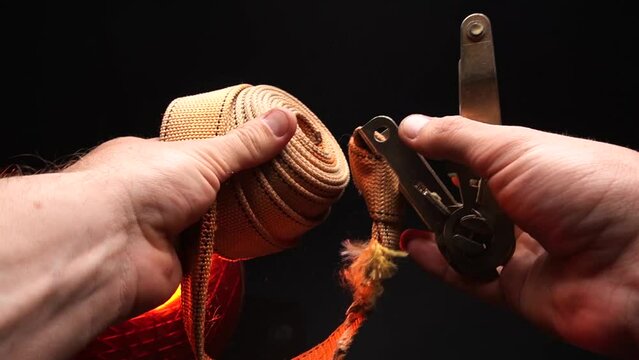 ratchet lashing straps orange operating principle in human hands 