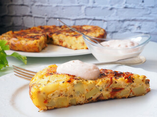 Spanish omelette with potatoes and Sun-Dried Tomatoes, Sauce, and Irresistible Slices in Focus
