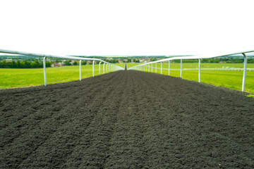 Wide angle, shallow depth of field of a flat racing horse racing track seen looking down to the...