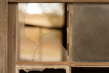 Old timber window frames with broken glass