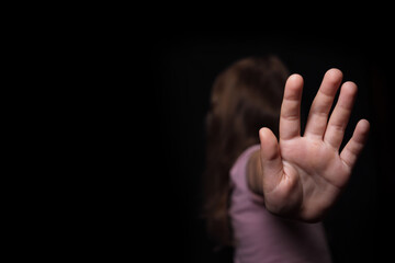 little girl child stretched her arm, defended against domestic violence, selective focus