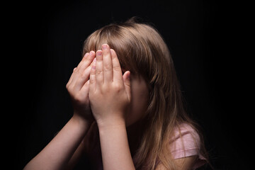 little girl crying on a black background