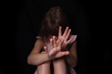 little girl child stretched her arm, defended against domestic violence, selective focus