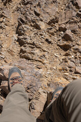 Hiker legs on rocky mountains