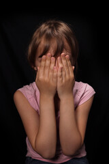 Sad depressed little girl crying closing her face