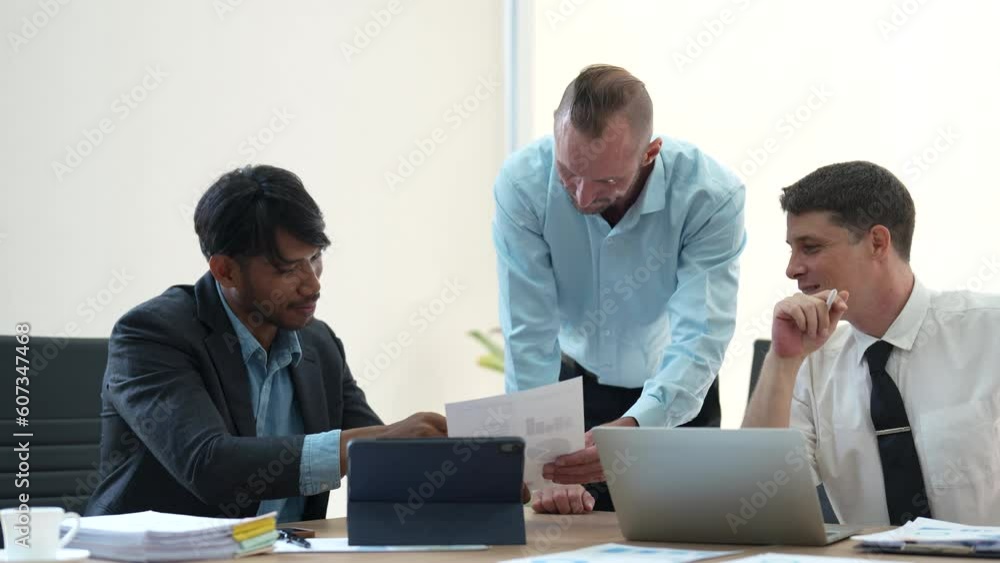 Poster diverse business team discussing market analysis sitting at desk in meeting. young man holding docum