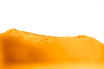 Orange juice splash to create surface and bubbles  isolated on white background.