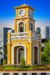 Clock tower on a roundabout in old phuket town at during the summer day surrounded by high-rise...