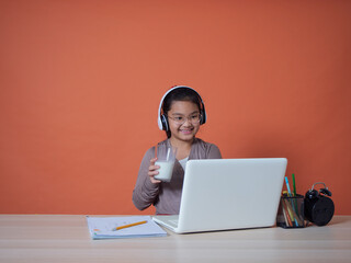 Cute little girl with laptop at table