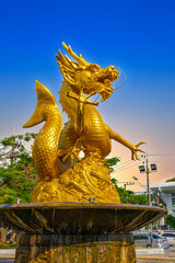 Golden dragon in old phuket town phuket Thailand this dragon is on the middle of a big water pond...