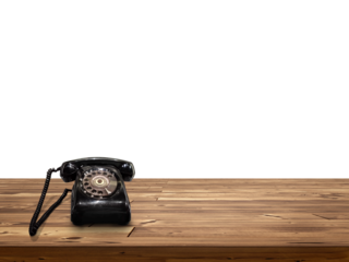 old black phone Placed on wooden table isolated on white background