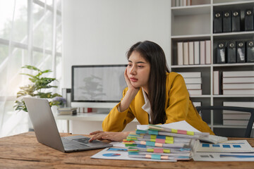 Asian business women are stressed while working on laptop and pile of documents, Tired asian businesswoman with headache at office, feeling sick at work