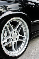 Car wheels close up on a background of asphalt. Car tires. Car wheel close-up