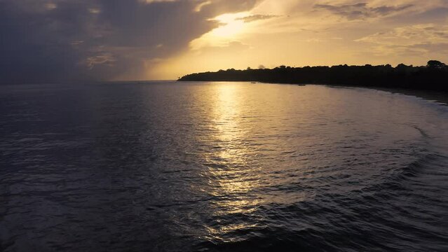 Calm ocean with thae reflection of the sunset