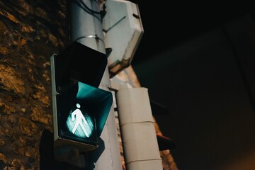 Fototapeta na wymiar Low angle shot of a green light at the pedestrian crossing