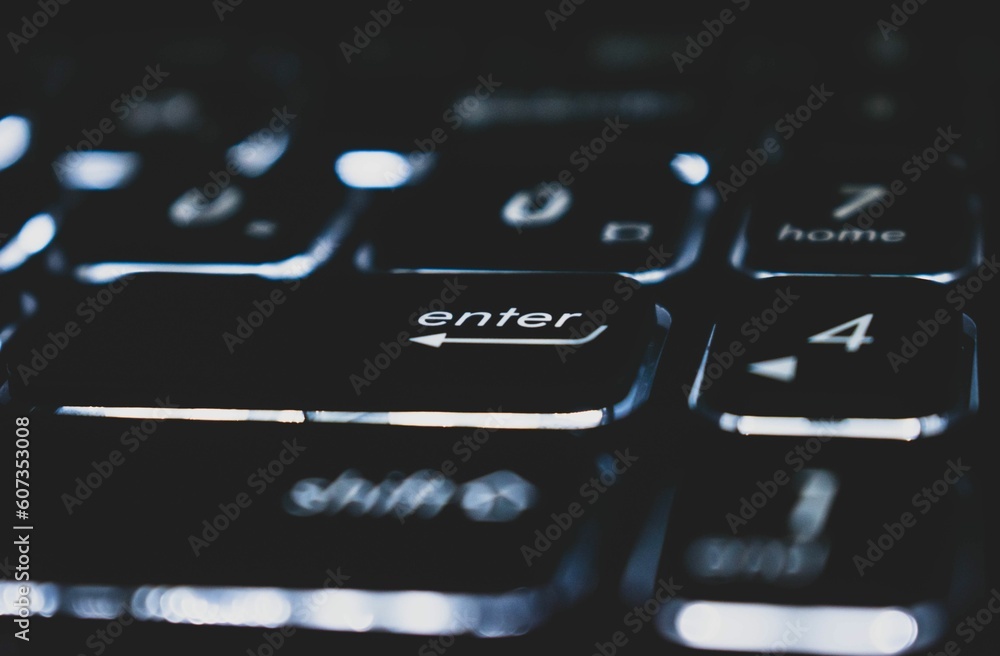 Poster closeup of the enter button on a keyboard of a laptop
