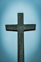 Vertical shot of a catholic cross in Huisnes German Cemetery, Normandy, France