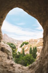 Landscape of a rocky cliff in the Pigeon Valley with trees, Cappadocia