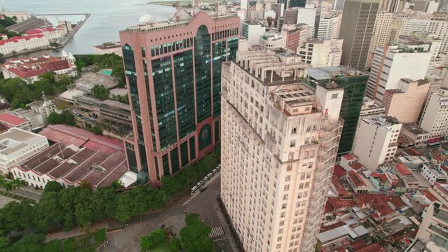 Aerial view circling above Metro line train passing through historic centre of Rio de Janeiro. Plaza Mau&aacute;, Building RB1