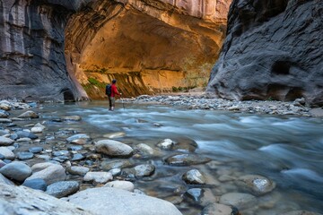 Long exposure of a man standing in the rocky river waves in Zion National Park
