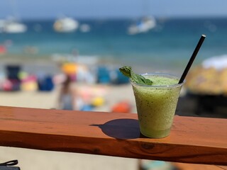 Closeup shot of a cup of Mojito mixed drink on the beach at Catalina Island, California