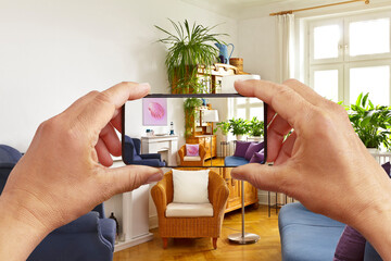 Augmented reality concept: hands holding smart phone with AR interior decoration app, visualising...