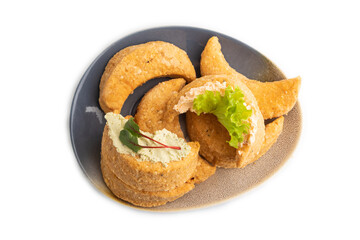 Homemade salted crescent-shaped cheese cookies isolated on white. top view.