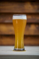 Vertical shot of a glass of beer on a table