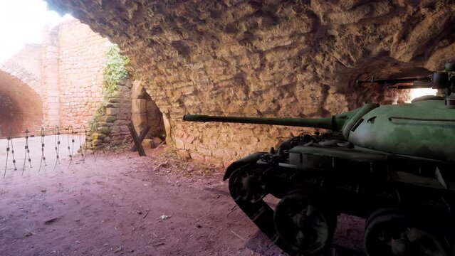 A platoon of military armored tanks hiding inside a cave to avoid detection during war and conflict.