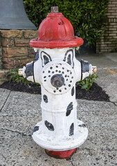 Fototapeta na wymiar Fire hydrant pained as a Dalmatian dog. 
