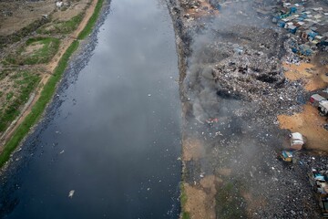 Drone shot of burning area near water