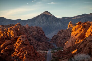 Aerial landscape of a highway road through a desert at sunrise at Valley of Fire © Randal Finklea/Wirestock Creators