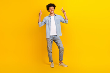 Full size photo of nice young man arms fingers demonstrate v-sign isolated on yellow color background