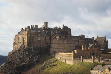 Exterior of the early medieval Edinburgh Castle and tourists visiting the historic fort