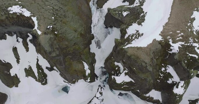 Aerial View of Waterfall and Ice in Highlands of Iceland. Fja&eth;r&aacute;rglj&uacute;fur Canyon Drone Shot 50fps