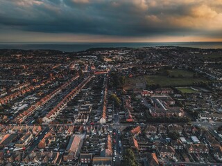 Fototapeta na wymiar Aerial view of industrial Kent city under cloudy sunset sky in London, England