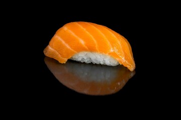 Salmon sushi isolated on a black background.