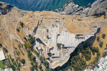 Top aerial of Lindos village on a sunlit rocky island with a seascape view, Rhodes, Greece